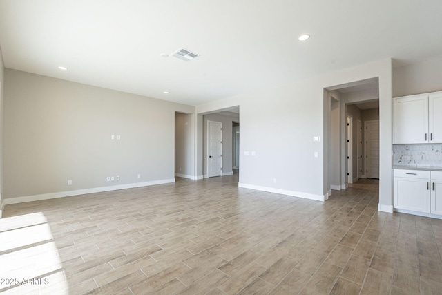 spare room with light hardwood / wood-style flooring