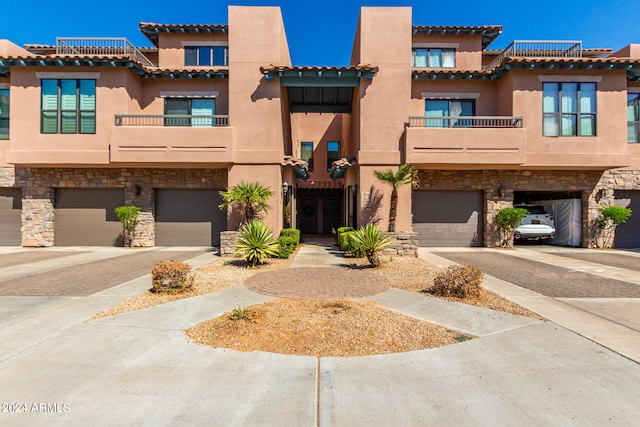 view of property featuring a balcony and a garage