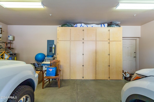 garage featuring washer / dryer, electric panel, and secured water heater