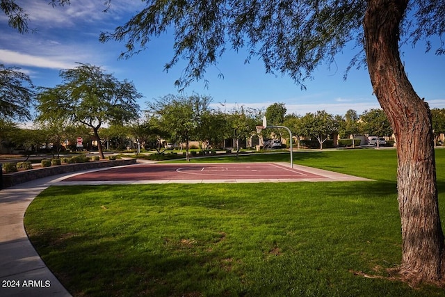 surrounding community with basketball court and a yard