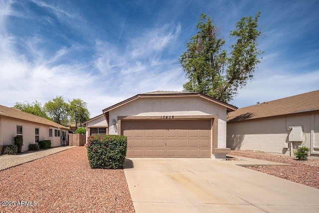 ranch-style home featuring fence, stucco siding, an attached garage, and driveway