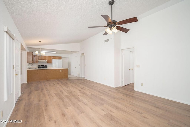 unfurnished living room featuring a textured ceiling, visible vents, ceiling fan with notable chandelier, lofted ceiling, and light wood-style floors