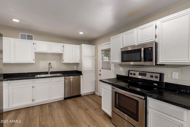 915 E Commonwealth Pl, Chandler, AZ 85225 - kitchen with stainless steel appliances, white cabinets, light wood-type flooring, and recessed lighting