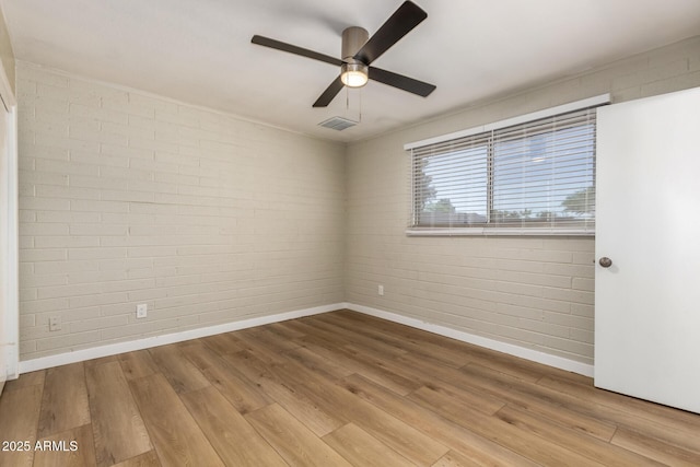 915 E Commonwealth Pl, Chandler, AZ 85225 - spare room with wood finished floors, a ceiling fan, and brick wall