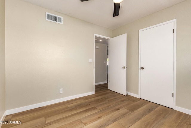 915 E Commonwealth Pl, Chandler, AZ 85225 - unfurnished bedroom featuring wood finished floors and a ceiling fan