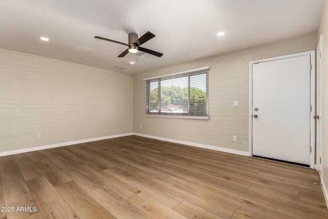 915 E Commonwealth Pl, Chandler, AZ 85225 - spare room with brick wall, a ceiling fan, and wood finished floors