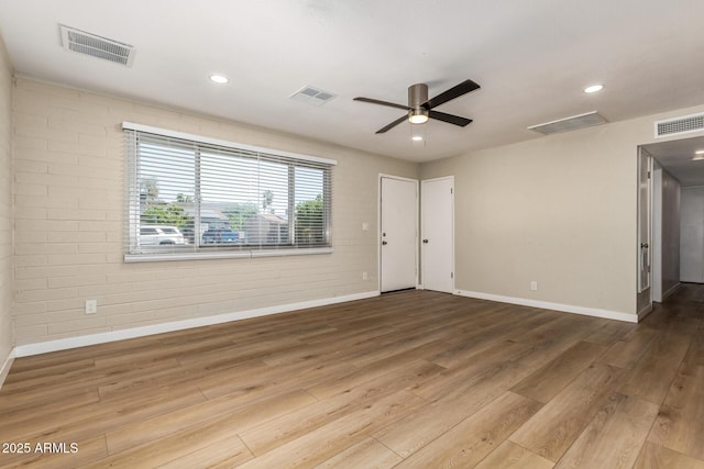 915 E Commonwealth Pl, Chandler, AZ 85225 - spare room featuring wood finished floors, ceiling fan, recessed lighting, and brick wall