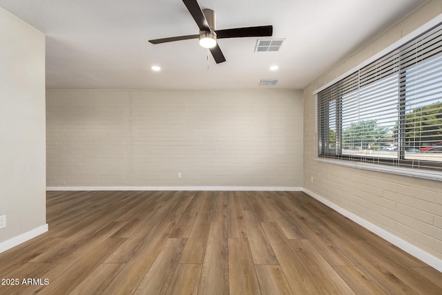 915 E Commonwealth Pl, Chandler, AZ 85225 - spare room with brick wall, wood finished floors, ceiling fan, and recessed lighting