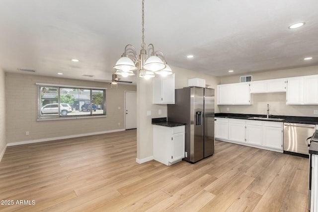 915 E Commonwealth Pl, Chandler, AZ 85225 - kitchen with appliances with stainless steel finishes, dark countertops, light wood-type flooring, recessed lighting, and white cabinetry