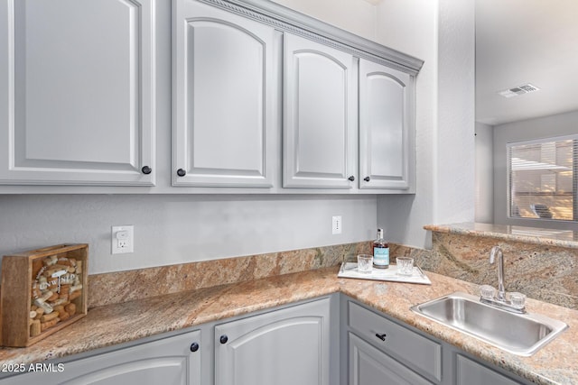 kitchen with sink and gray cabinetry