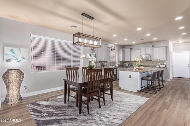 dining space with light hardwood / wood-style floors