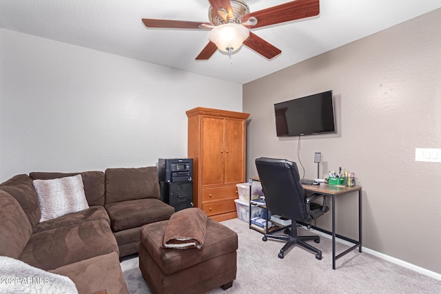 carpeted home office with ceiling fan