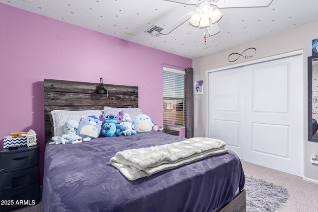 bedroom with a closet, ceiling fan, and carpet flooring