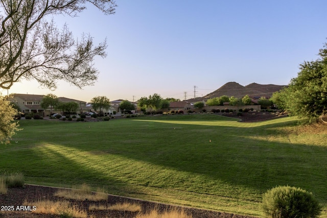 yard at dusk featuring a mountain view