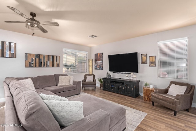 living room featuring ceiling fan and light wood-type flooring