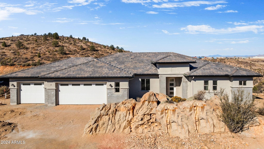 view of front of property featuring a garage and a mountain view