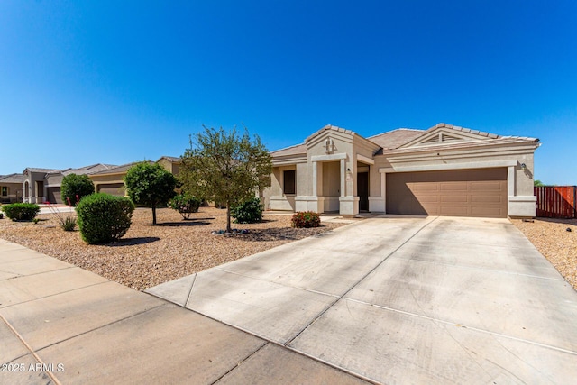 10653 E Sunflower Ct, Florence, AZ 85132 - view of front of home featuring a garage, stucco siding, driveway, and a tile roof