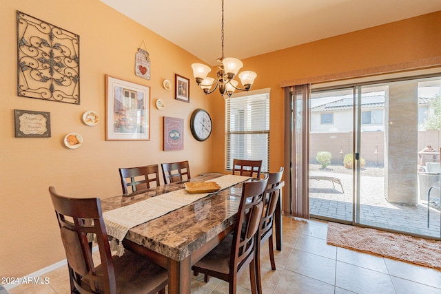 dining space featuring light tile patterned floors and an inviting chandelier