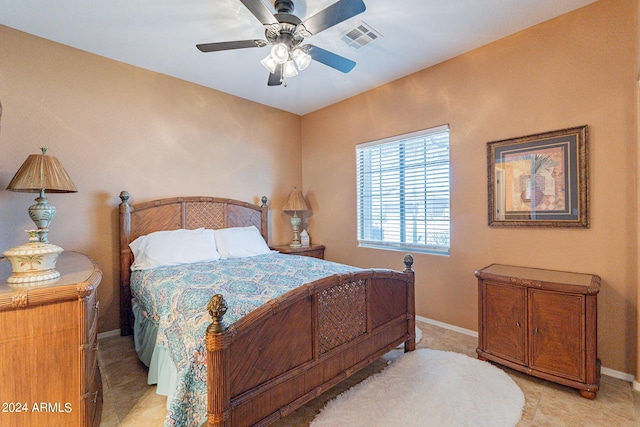 tiled bedroom with ceiling fan