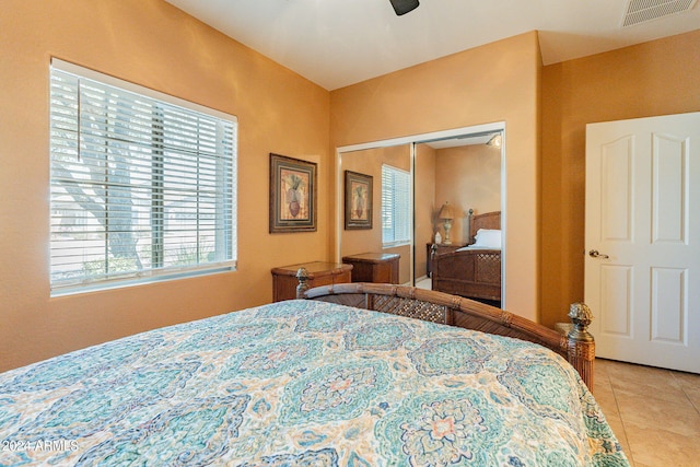 bedroom featuring tile patterned flooring, ceiling fan, and a closet