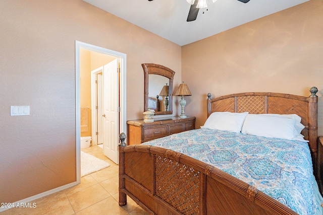 tiled bedroom featuring ceiling fan and ensuite bathroom