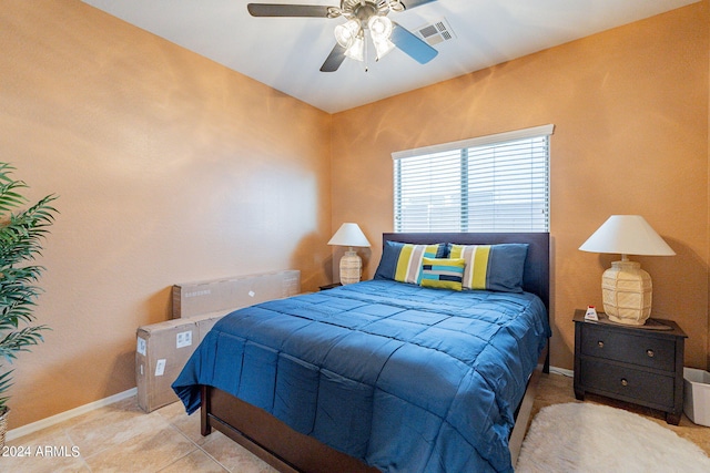 bedroom with ceiling fan and light tile patterned floors