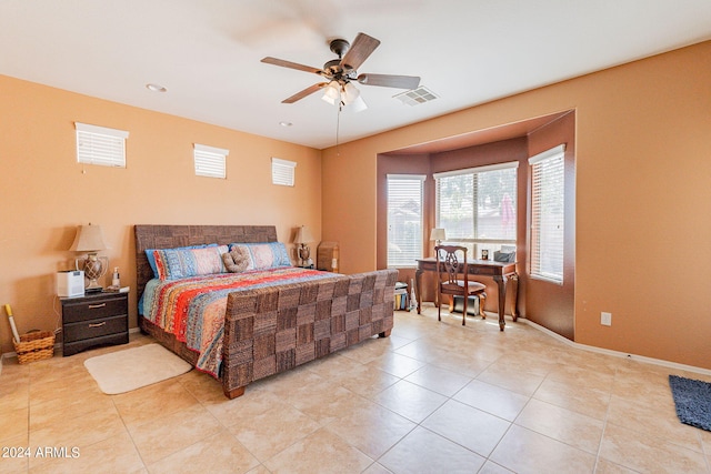 bedroom with ceiling fan and light tile patterned floors