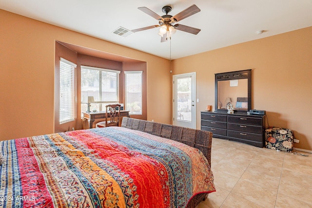 tiled bedroom featuring ceiling fan