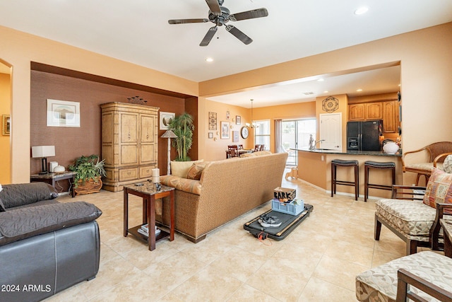 tiled living room featuring ceiling fan