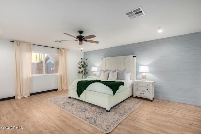 bedroom with light hardwood / wood-style floors and ceiling fan