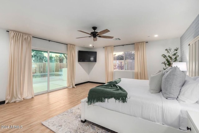 bedroom with light hardwood / wood-style flooring, access to outside, and ceiling fan