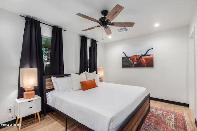 bedroom featuring hardwood / wood-style floors and ceiling fan