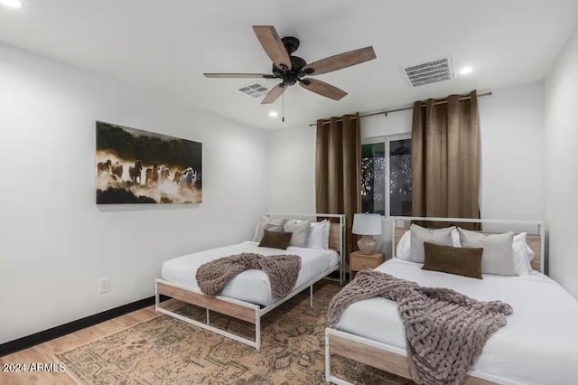 bedroom featuring wood-type flooring and ceiling fan