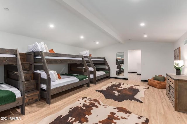 bedroom with vaulted ceiling with beams and light hardwood / wood-style flooring