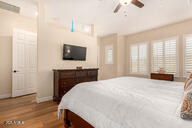 bedroom with ceiling fan and wood-type flooring