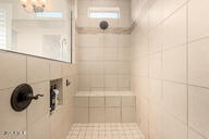 bathroom featuring a tile shower