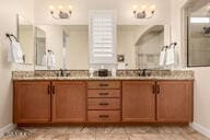 bathroom featuring a shower and vanity