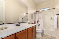 full bathroom with tile patterned floors, vanity, toilet, and shower / bathtub combination with curtain