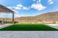 view of yard with a mountain view and a patio