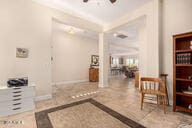 tiled entrance foyer featuring ceiling fan