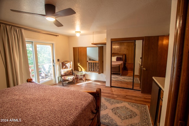 bedroom featuring ceiling fan, a textured ceiling, and light wood-type flooring