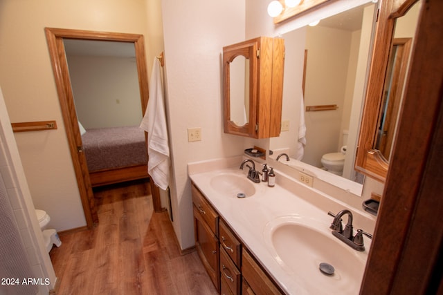 bathroom featuring vanity, hardwood / wood-style flooring, and toilet