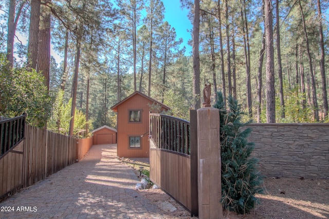 view of gate with an outbuilding