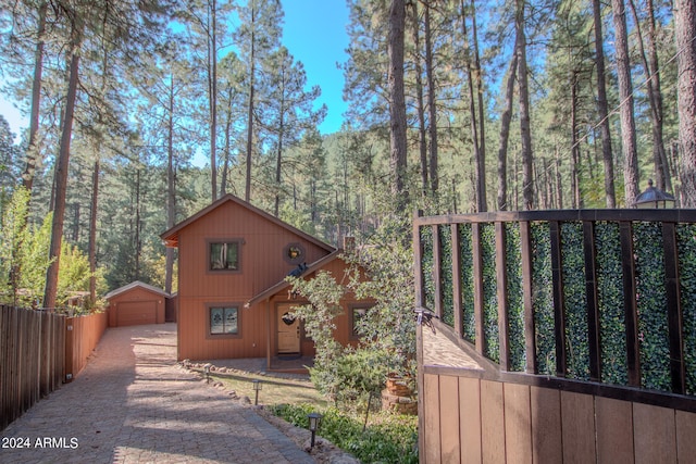 view of side of home featuring an outbuilding and a garage