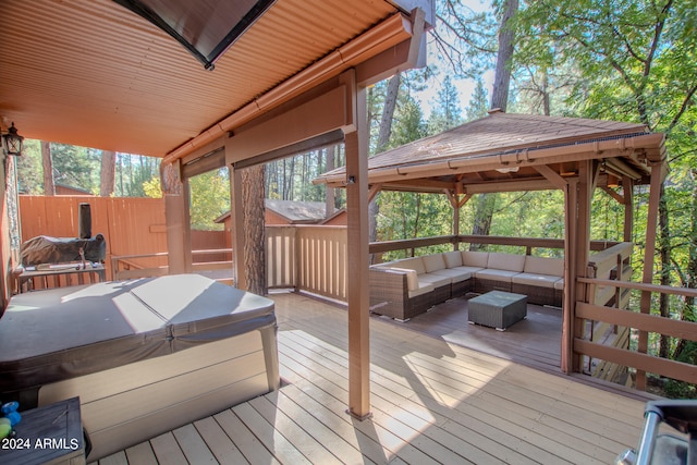 deck with a gazebo, a hot tub, and a grill