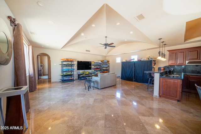 living room with recessed lighting, ceiling fan, visible vents, arched walkways, and lofted ceiling