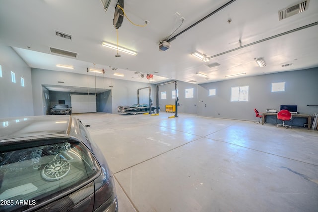 garage with visible vents and a garage door opener