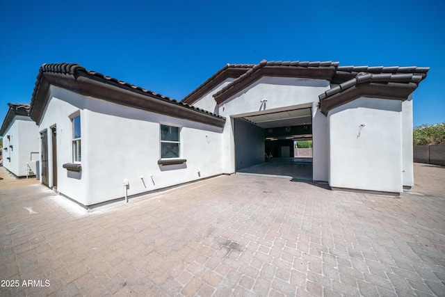 view of front of property featuring stucco siding and a tiled roof
