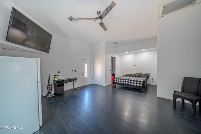 bedroom with visible vents, wood finished floors, ceiling fan, and freestanding refrigerator