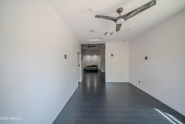 hallway with visible vents and dark wood finished floors